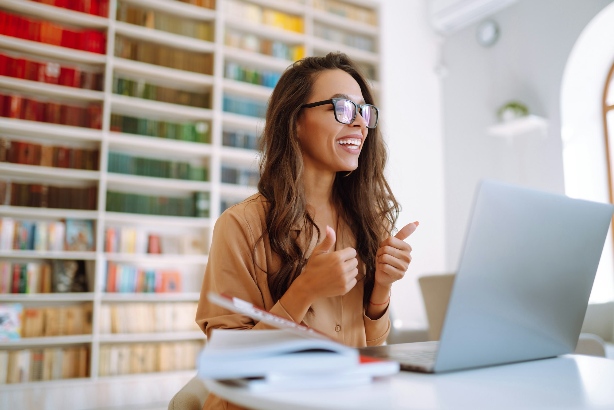 Portrait of happy young woman with laptop. Freelancer working on laptop. Business, online concept.