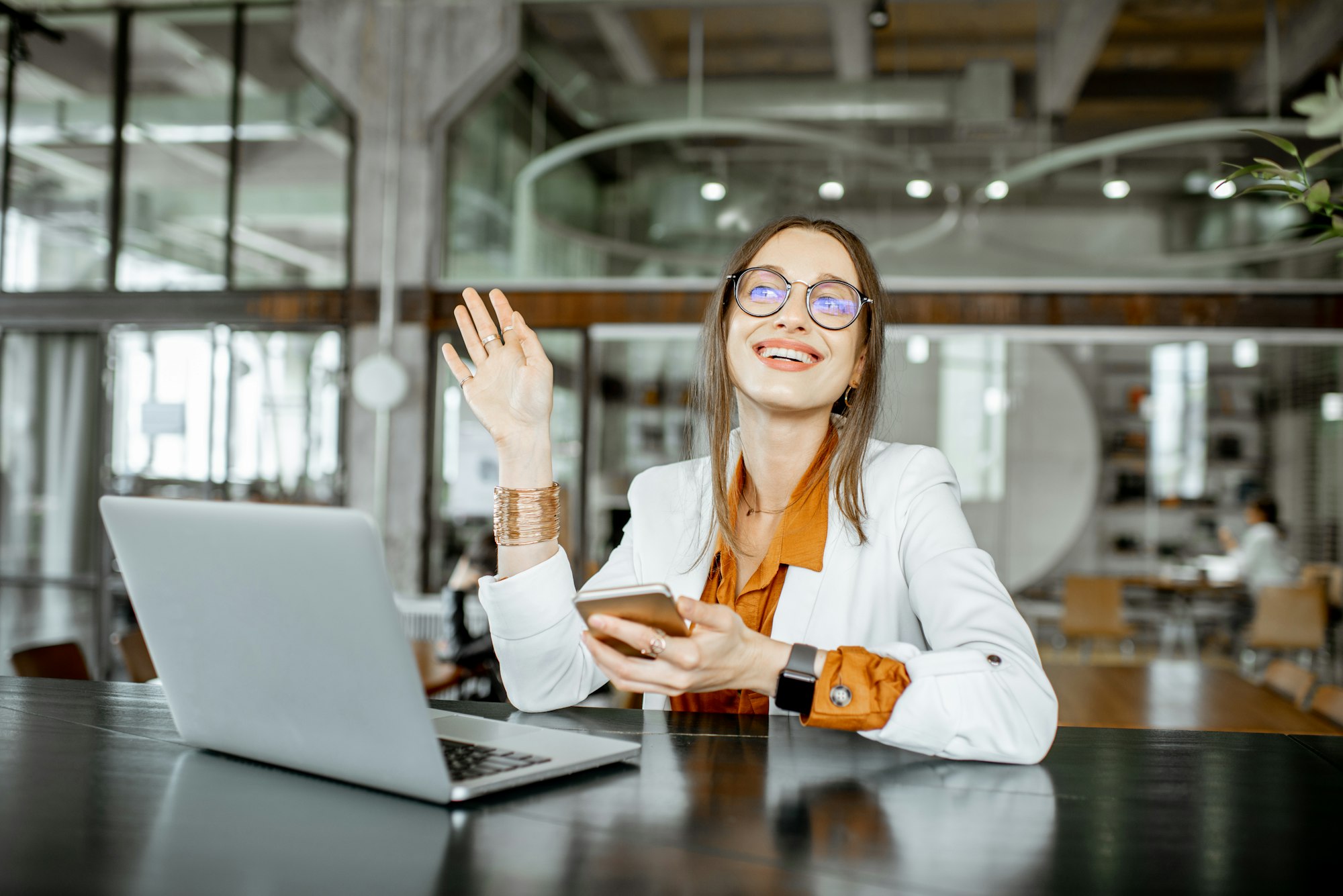 Young businesswoman with laptop in the bar